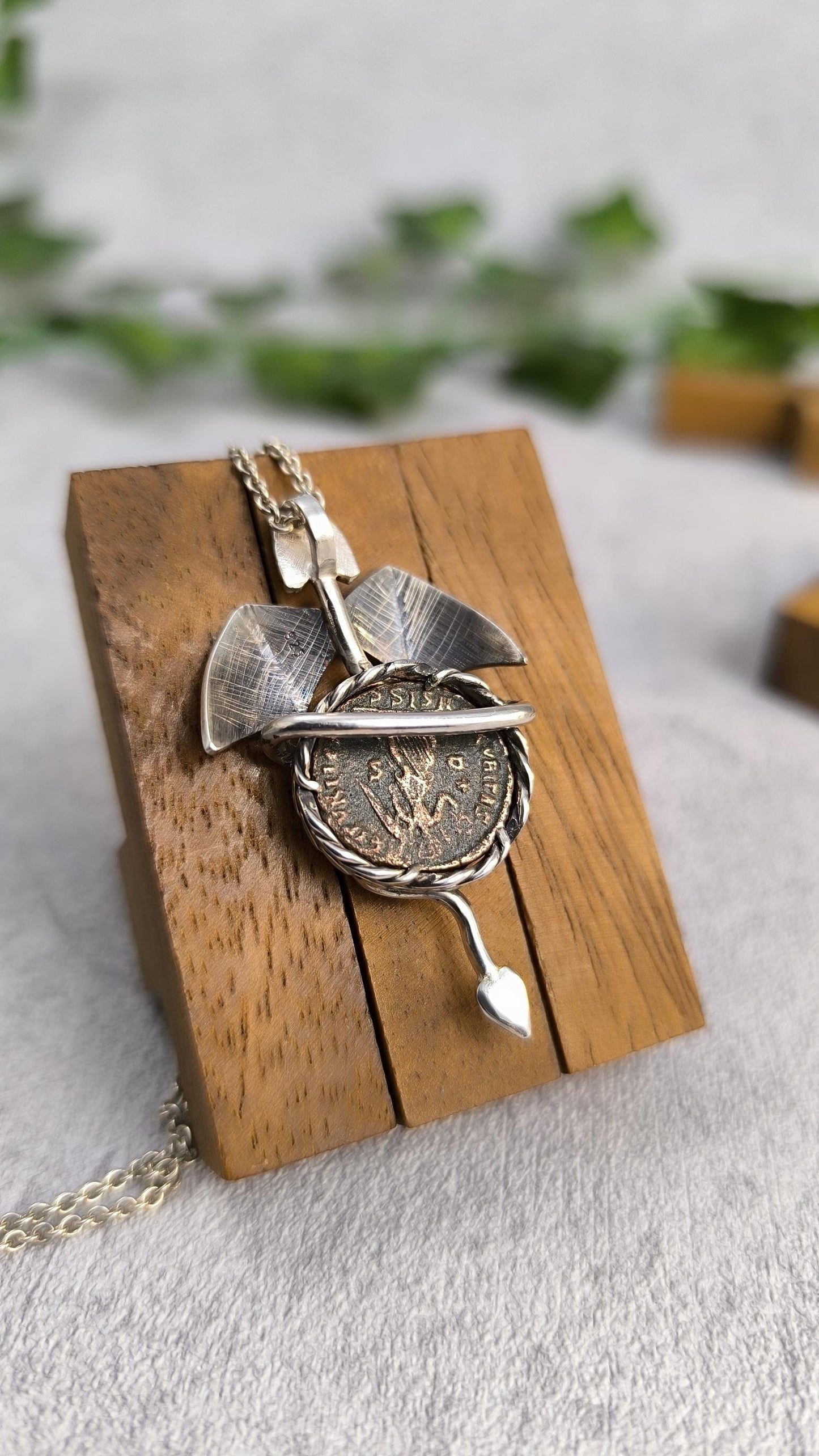 Dragon carrying an authentic roman coin